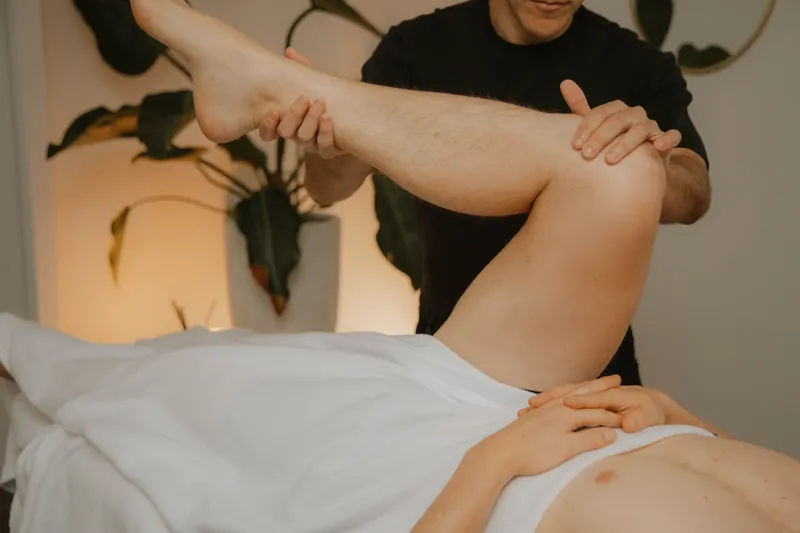 Assisted hamstring stretch with the leg raised